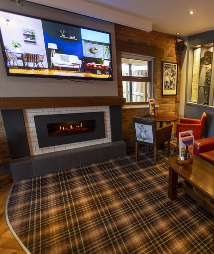 interior of the restaurant with seating area and TV