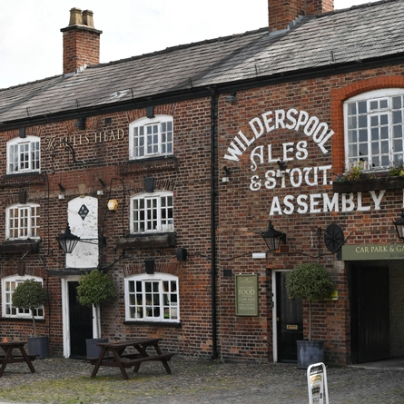 The exterior facade and beer garden seating area at The Bulls Head.
