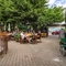 The exterior patio beer garden seating area with wooden tables, chairs, heaters and lighting at The Duke Of Sussex.