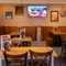 The interior restaurant and seating area with TV at the Woodlands Edge.