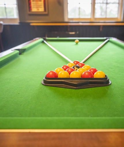 Interior area of a pub with a pool table.