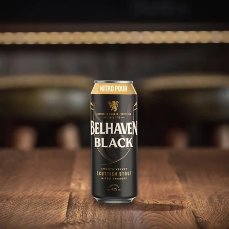 An advertising image of a can of Belhaven Black in a Nitro Can sat on a wooden table.