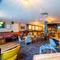 The bar and interior restaurant seating area at the Counting House, with TVs on the walls, and upholstered booth seating.