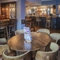 Interior dining area of a pub with a bar and a TV.