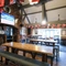 Interior dining area of a pub with a fireplace and a TV.