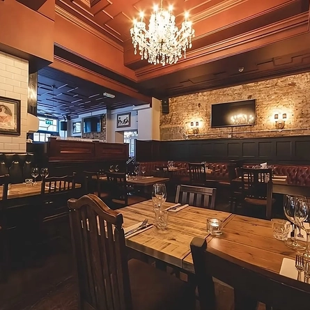 The interior restaurant seating area with TV at the Phoenix in Whitechapel.