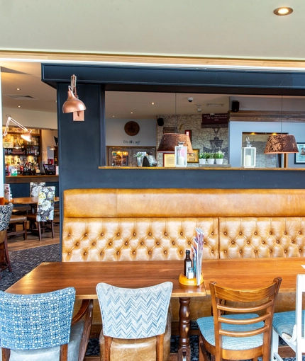 Interior dining area of a pub with a bar.