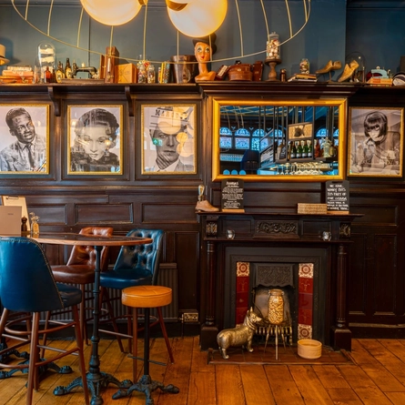 The interior seating area, fireplace and decor at The Blue Posts.