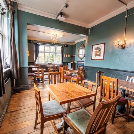 The interior restaurant seating area with a tiled fireplace within one of the function rooms at The Vine.