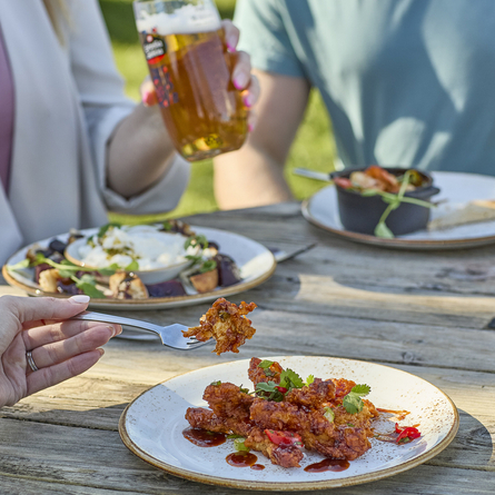 An image showing the sticky barbeque chicken dish served on a plate at Chef & Brewer.