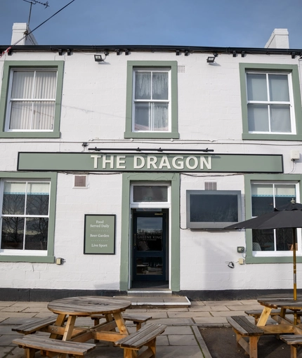 The exterior facade with seating area at the Dragon.