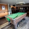 Interior dining area of a pub with a pool table.