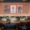 An interior restaurant seating area at The Royal Oak, with an upholstered booth seat, and framed artwork on the wall above it.