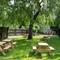 Exterior beer garden of a pub with a seating area and a play area.