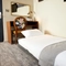 A bed in a hotel room of The Narborough Arms.
