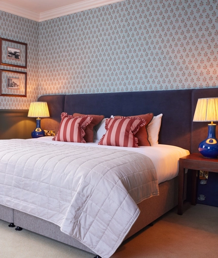 Double bed in hotel room with a sofa bed 