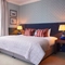 Double bed in hotel room with a sofa bed 