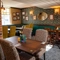 The interior restaurant seating area of The Fox, with booth seating, and framed artwork on the walls.