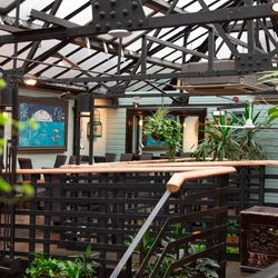 An interior shot of the seating area in the conservatory at the Ubiquitous Chip in Glasgow.