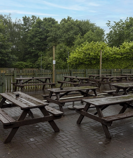Exterior beer garden of a pub with a seating area.