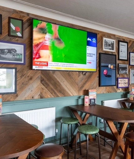 An interior shot of the restaurant, sport and seating area at the Waterside in Shoreham-By-Sea.