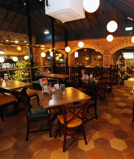 Interior dining area with tables and chairs.