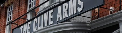 A close up image of the exterior venue signage at The Clive Arms.