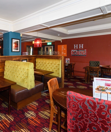 Interior dining area of a pub with a bar.