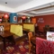 Interior dining area of a pub with a bar.