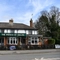 Exterior facade of a pub with a seating area
