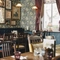 Interior restaurant area of the Sherlock holmes venue, with wooden tables and wallpapered walls