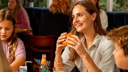 An image of a family enjoying a meal and drinks within the interior restaurant and seating area at a Hungry Horse venue.