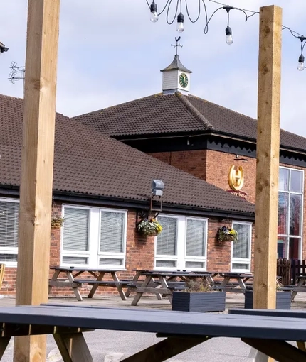The exterior facade with seating area at the Kingstown Hotel.
