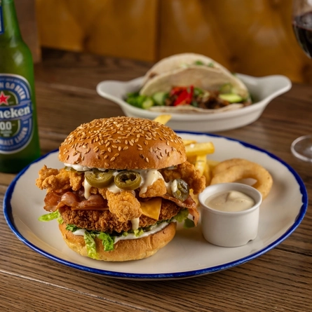A plated Crispy Double Chicken Ranch Burger on a wooden table.