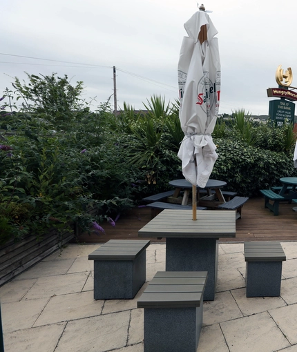 Exterior beer garden of a pub with a seating area.