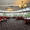 Interior dining area of a pub in a conservatory.