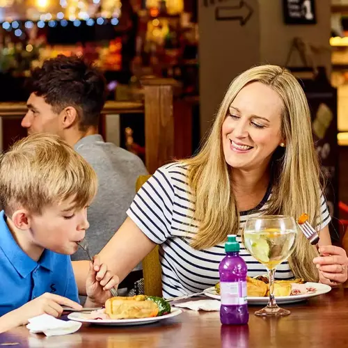 A family enjoying a meal at a Greene King pub