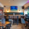 The interior restaurant and seating area with TV and slot machine at the Poachers 