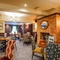 The interior restaurant seating area with feature fireplace at The Two Greens.