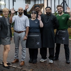 A group of people stood smiling at the camera.