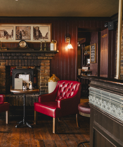The interior restaurant and seating area with fireplace at the Three Tuns.