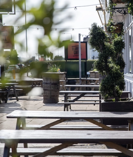 Exterior beer garden of a pub with a seating area.