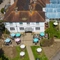 A birdseye view of the exterior facade and seating area at the Cedars Inn.