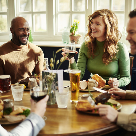 A group of people enjoying a roast dinner.