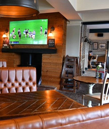 interior of the restaurant and seating area with TV