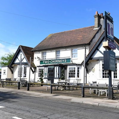 Exterior facade of a pub with a seating area.