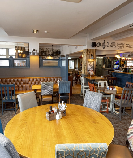 Interior dining area of a pub with a bar.