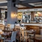Interior dining area of a pub with a bar.