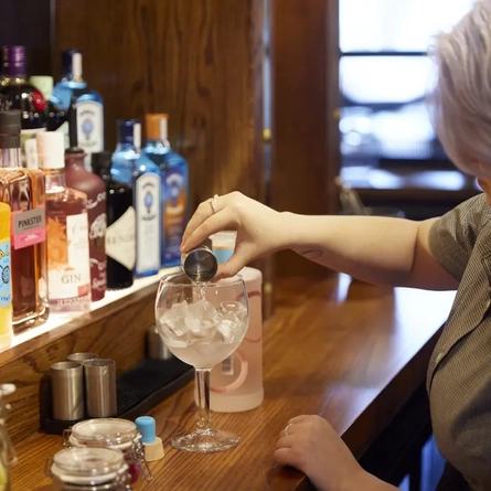 A team member creating a Gin and Tonic