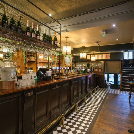 The bar at the Museum, with tables alongside it.